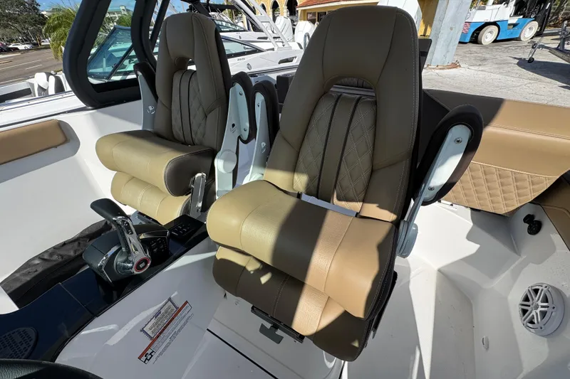 Slide: The Image of Luxury seating in 2026 Monterey Elite 27 OB boat cockpit, featuring premium leather upholstery. - 7