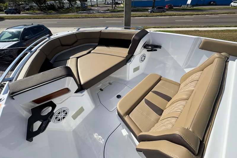 Slide: The Image of 2026 Monterey Elite 27 OB boat interior with tan seating and cup holders. - 9