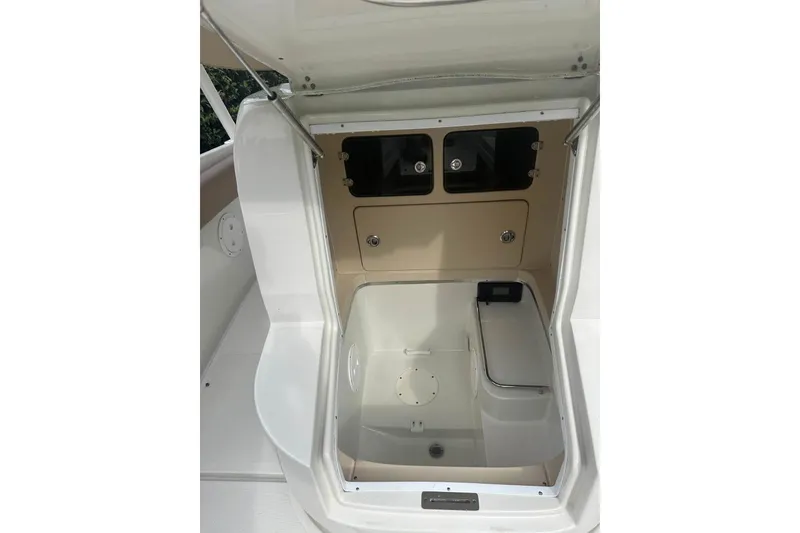 Slide: The Image of 2016 Chris-Craft Catalina 23 boat interior storage compartment, open hatch view. - 2