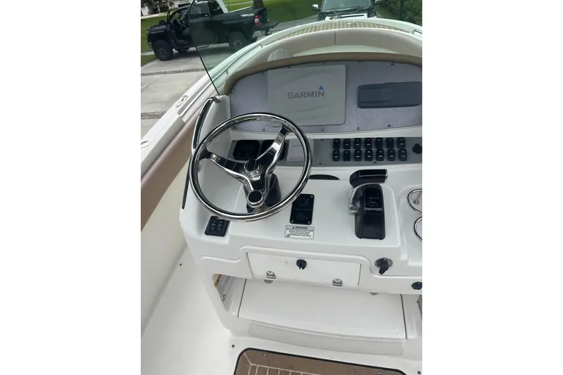 Slide: The Image of 2016 Chris-Craft Catalina 23 helm with Garmin navigation system and steering wheel. - 3