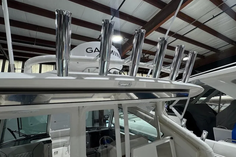 Slide: The Image of 2026 Pursuit DC 326 Dual Console boat with chrome rod holders and Garmin equipment. - 10