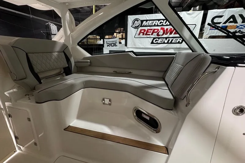 Slide: The Image of 2026 Pursuit DC 326 Dual Console interior with gray seating and modern design. - 12