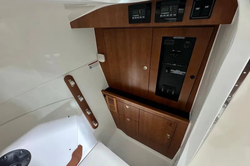 Slide: The Image of 2026 Pursuit DC 326 Dual Console interior with wood paneling and control panels. - 13