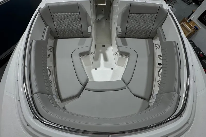 Slide: The Image of 2026 Pursuit DC 326 Dual Console boat interior with gray seating and modern design. - 19