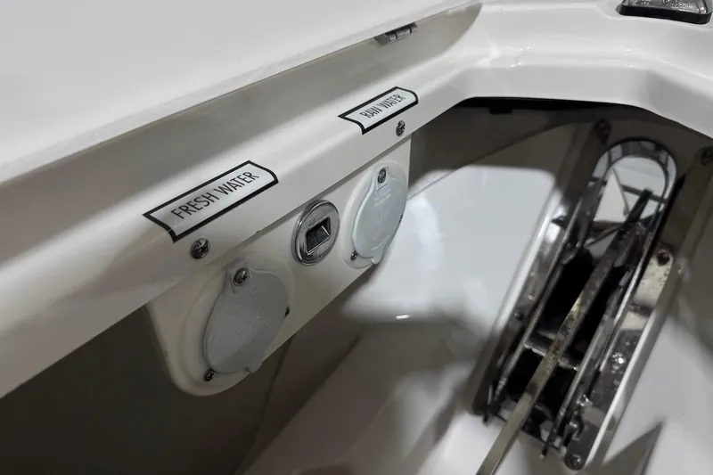 Slide: The Image of Fresh and raw water access on 2026 Pursuit DC 326 Dual Console boat. - 21