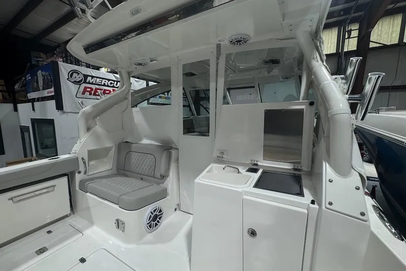 Slide: The Image of 2026 Pursuit DC 326 Dual Console interior with seating and storage in a showroom. - 24