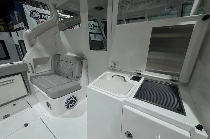 Slide: The Image of 2026 Pursuit DC 326 Dual Console interior with seating and kitchenette area. - 25
