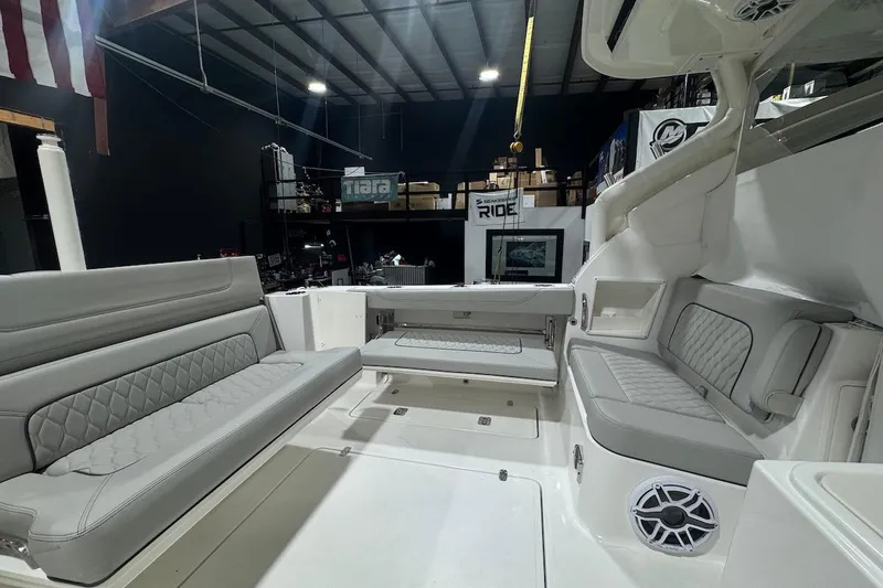 Slide: The Image of 2026 Pursuit DC 326 Dual Console interior with luxurious seating and modern design. - 26