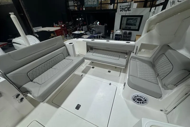 Slide: The Image of 2026 Pursuit DC 326 Dual Console boat interior with gray seating and modern design. - 27