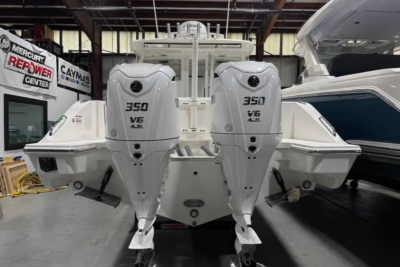 Slide: The Image of 2026 Pursuit DC 326 Dual Console with twin 350 V6 engines in a showroom. - 3