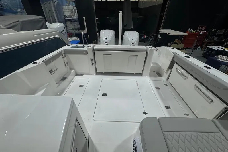 Slide: The Image of 2026 Pursuit DC 326 Dual Console boat interior with spacious deck and storage compartments. - 30