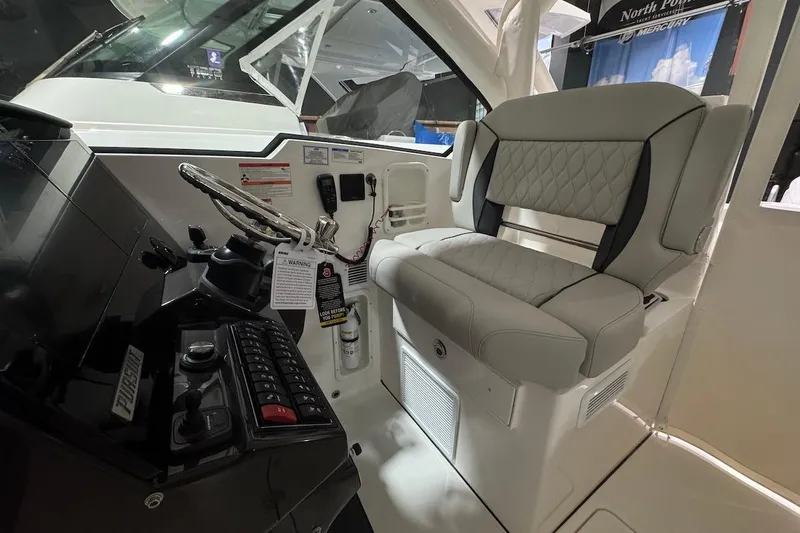 Slide: The Image of 2026 Pursuit DC 326 Dual Console interior with steering wheel and cushioned seating. - 8