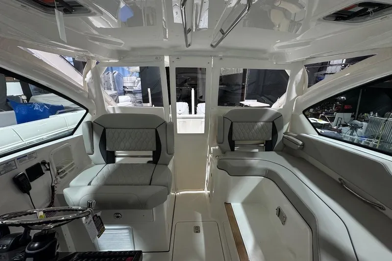 Slide: The Image of 2026 Pursuit DC 326 Dual Console interior with modern seating and sleek design. - 9