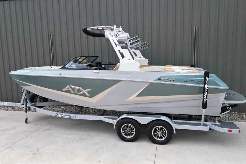 Slide: The Image of 2026 ATX Surf Boats 22 Type-S on trailer, sleek design, parked outdoors. - 3