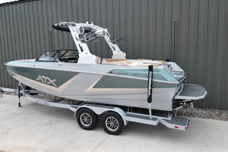 Slide: The Image of 2026 ATX Surf Boats 22 Type-S on trailer, sleek design, parked outdoors. - 4