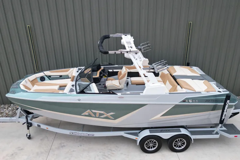 Slide: The Image of 2026 ATX Surf Boats 22 Type-S on trailer, sleek design with beige and green accents. - 6