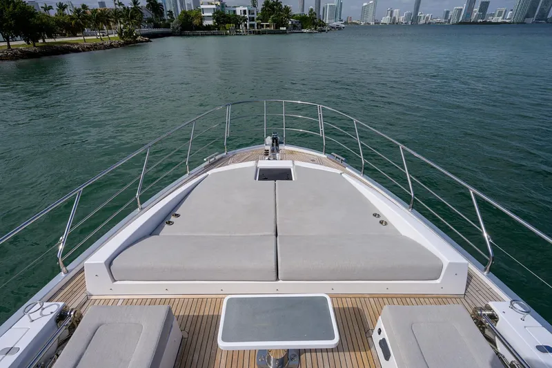 Slide: The Image of 2019 Azimut S7 yacht bow with sunbathing area and scenic waterfront view. - 25
