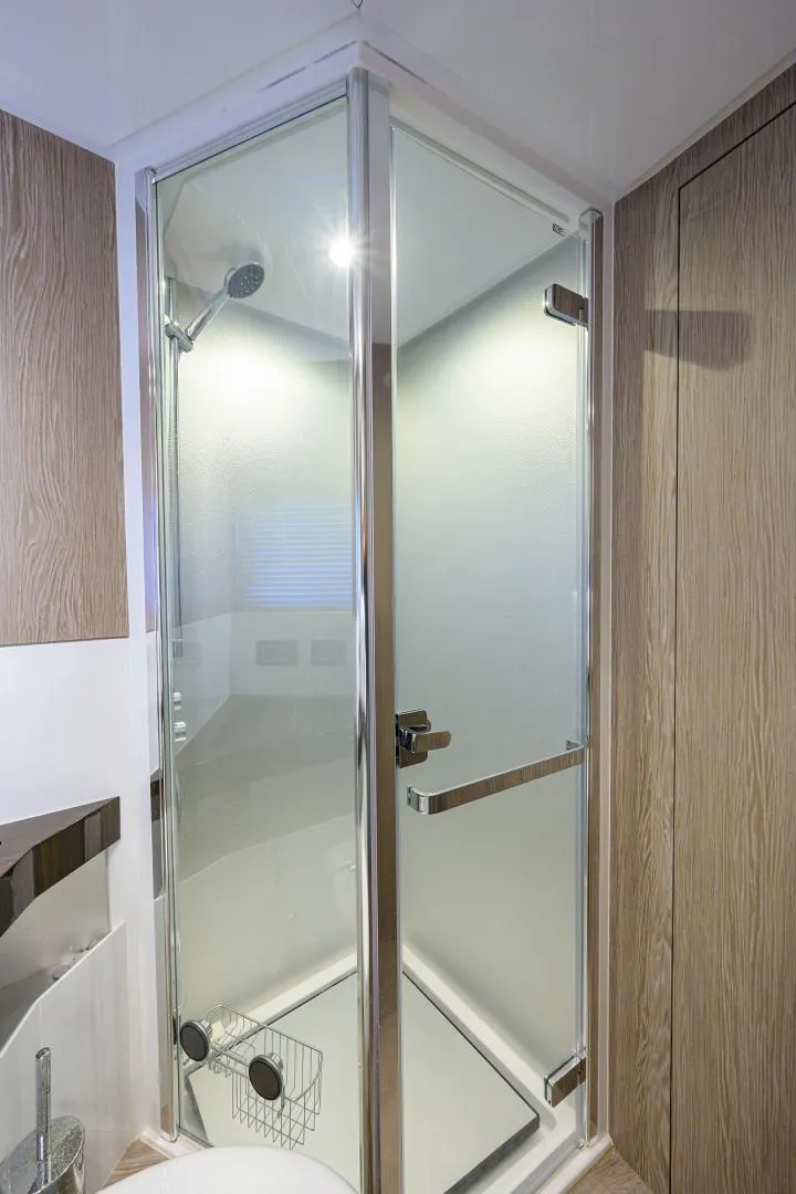 Slide: The Image of Modern shower in 2019 Azimut S7 yacht with glass door and wooden accents. - 49