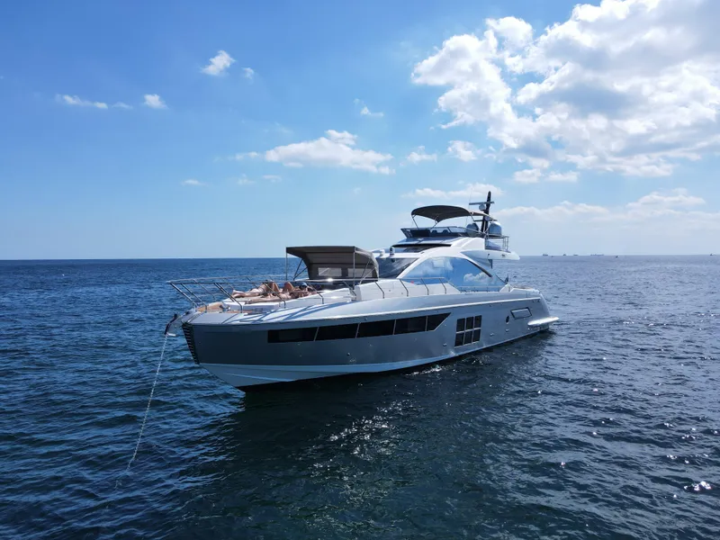 Slide: The Image of 2019 Azimut S7 yacht cruising on open water under a clear sky. - 5