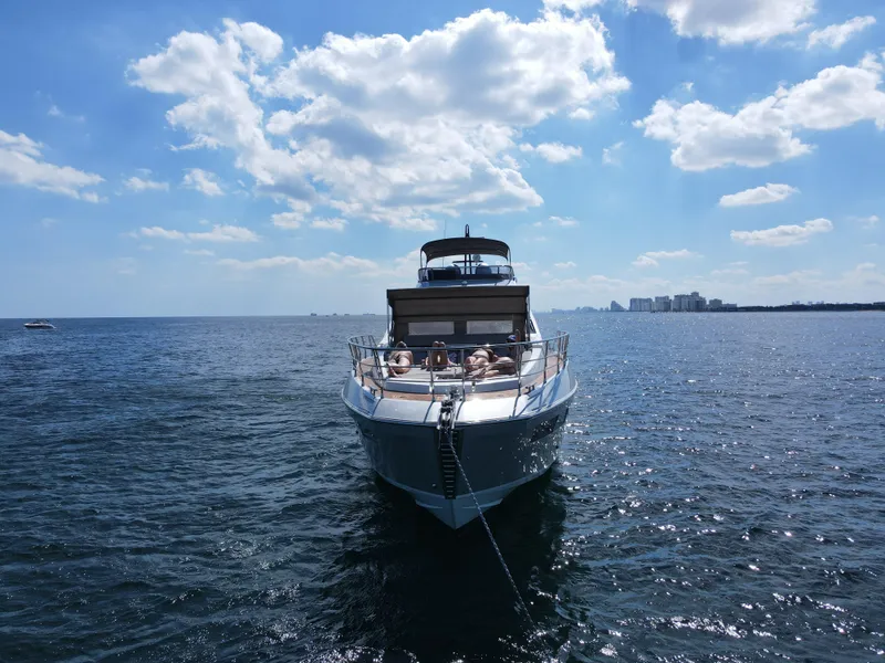 Slide: The Image of 2019 Azimut S7 yacht cruising on a sunny day with people relaxing on deck. - 7