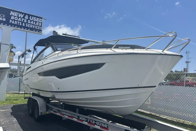 The Image of 2022 Parker Poland 850 Voyager boat on trailer at sales lot under clear sky. - 1