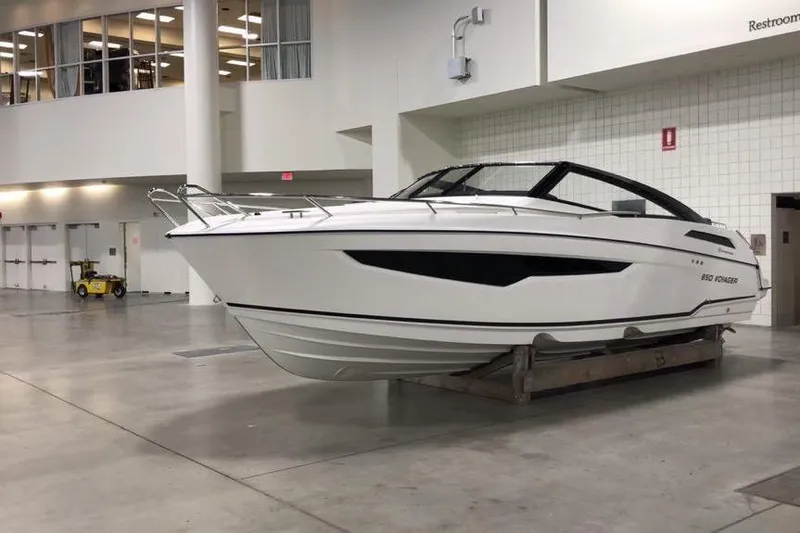 Slide: The Image of 2022 Parker Poland 850 Voyager boat displayed indoors on a stand. - 13