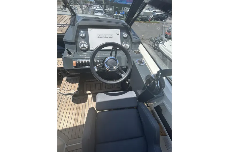 Slide: The Image of Cockpit of 2022 Parker Poland 850 Voyager boat with steering wheel and control panel. - 3