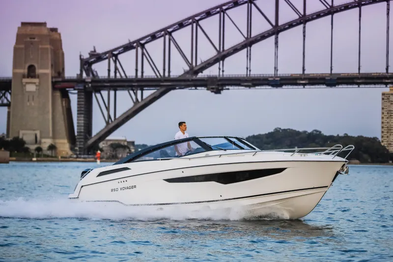 Slide: The Image of 2022 Parker Poland 850 Voyager cruising near iconic bridge at sunset. - 11