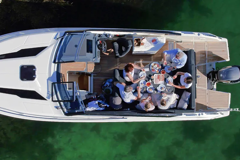 Slide: The Image of Overhead view of people dining on a 2022 Parker Poland 850 Voyager boat. - 9