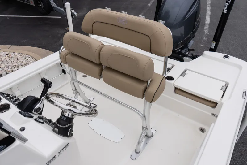 Slide: The Image of 2020 NauticStar 215 XTS boat interior with beige seating and steering wheel. - 10