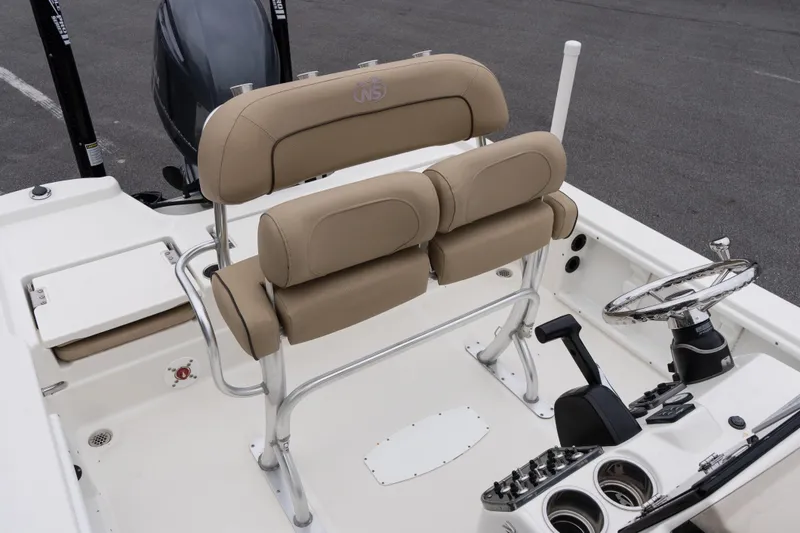 Slide: The Image of 2020 NauticStar 215 XTS boat interior with tan seating and steering console. - 11