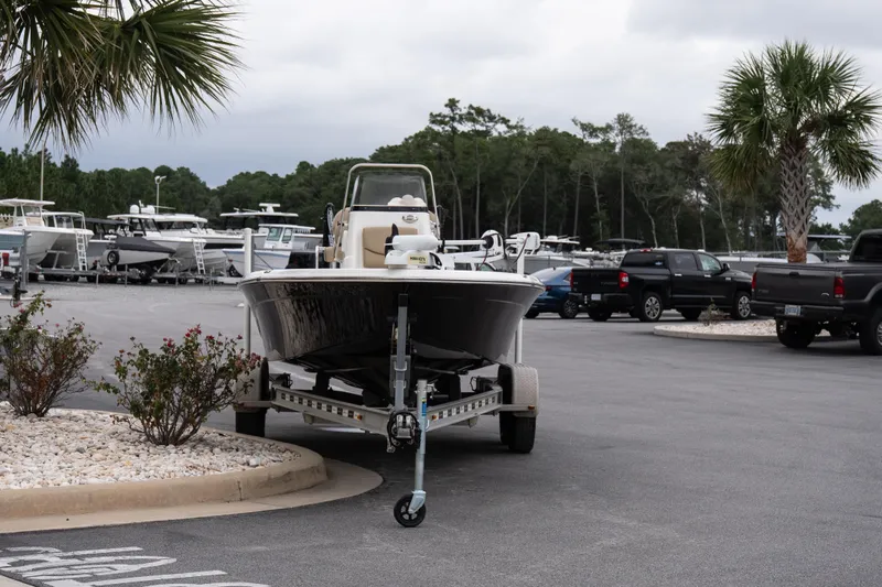 Slide: The Image of 2020 NauticStar 215 XTS boat on trailer in parking lot with palm trees. - 3