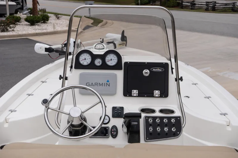 Slide: The Image of 2020 NauticStar 215 XTS boat dashboard with Garmin navigation and steering wheel. - 9