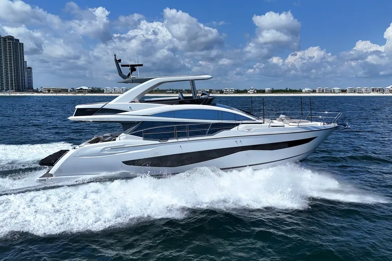 The Image of 2022 Pearl 62 yacht cruising on ocean with city skyline in background. - 0
