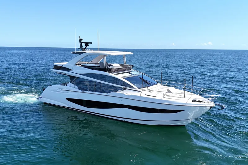 Slide: The Image of Luxurious 2022 Pearl 62 yacht cruising on open sea under clear blue sky. - 1