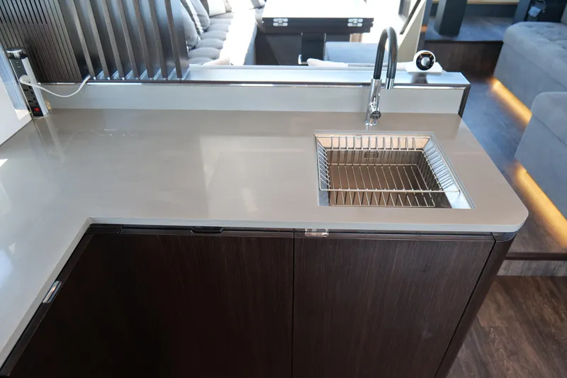 Slide: The Image of Modern kitchen sink in 2022 Pearl 62 yacht with sleek countertop design. - 13