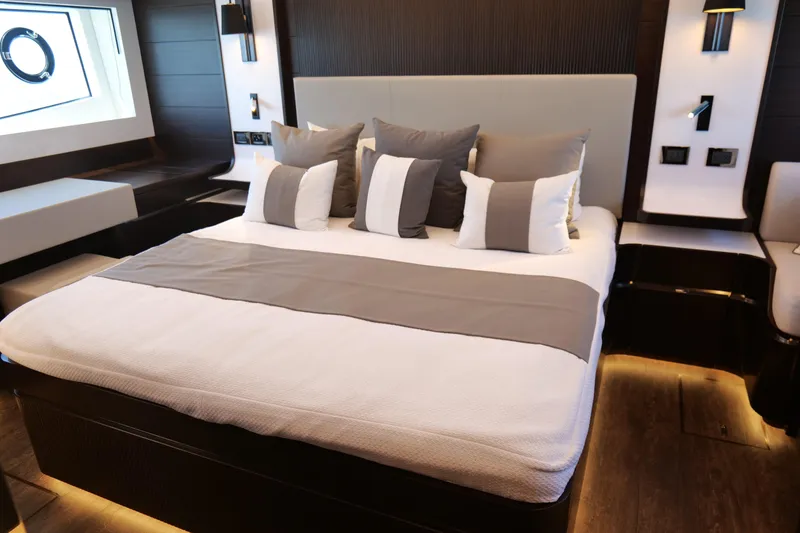 Slide: The Image of Luxurious bedroom interior on 2022 Pearl 62 yacht with modern design and elegant decor. - 22