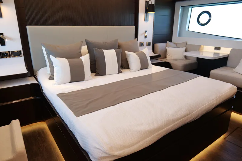 Slide: The Image of Luxurious bedroom interior on 2022 Pearl 62 yacht, featuring elegant bedding and modern design. - 23