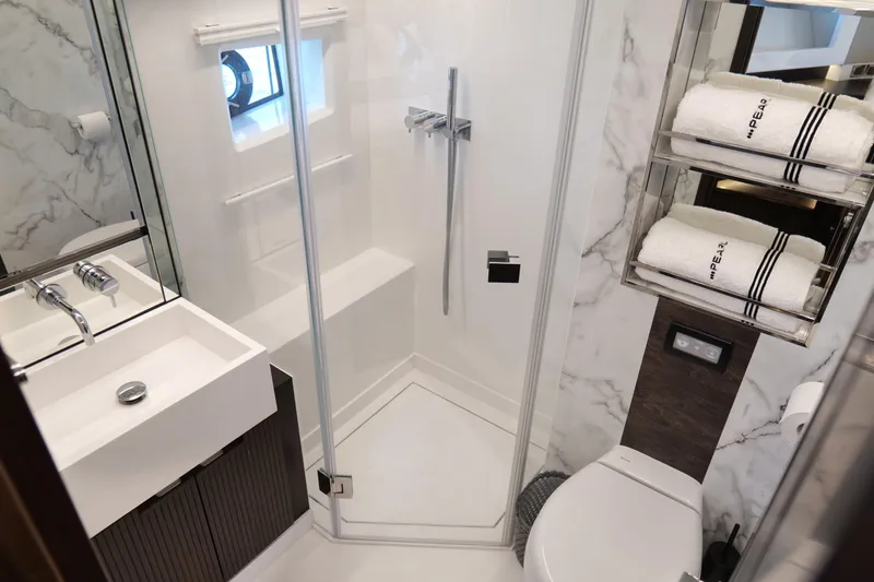 Slide: The Image of Luxurious 2022 Pearl 62 yacht bathroom with modern shower, sink, and towel storage. - 35