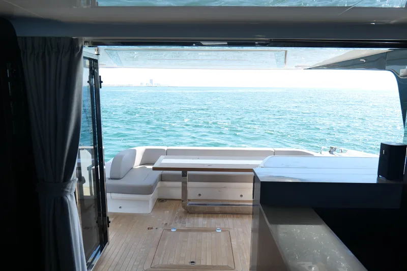 Slide: The Image of Luxurious Pearl 62 yacht interior with ocean view, featuring elegant seating and dining area, 2022 model. - 42