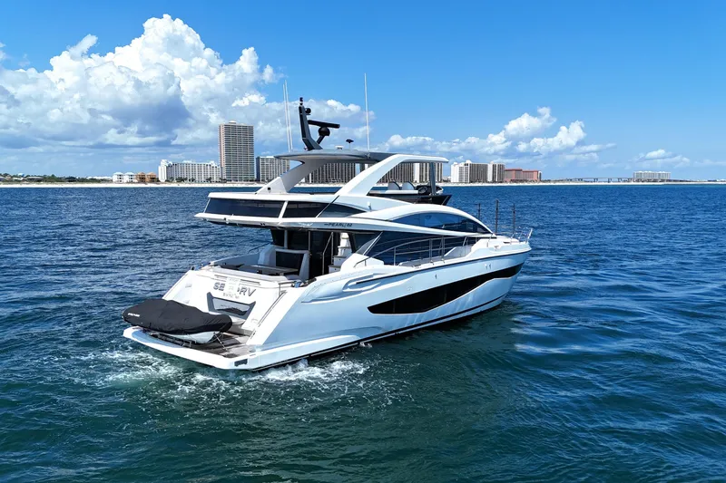 Slide: The Image of Luxurious 2022 Pearl 62 yacht cruising on a sunny day near coastal cityscape. - 6