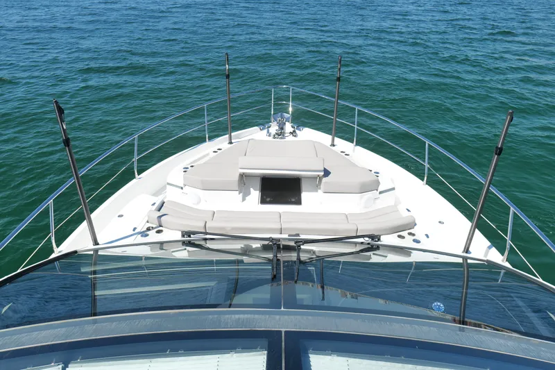 Slide: The Image of 2022 Pearl 62 yacht bow view with sunbathing area on open water. - 63