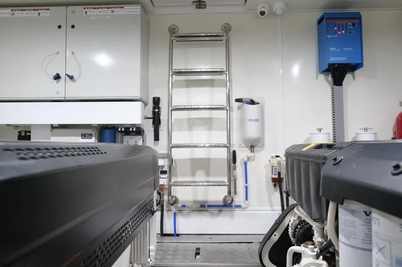 Slide: The Image of Engine room of 2022 Pearl 62 yacht with equipment and ladder. - 67