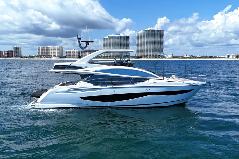 Slide: The Image of Luxurious 2022 Pearl 62 yacht cruising on ocean with city skyline backdrop. - 7