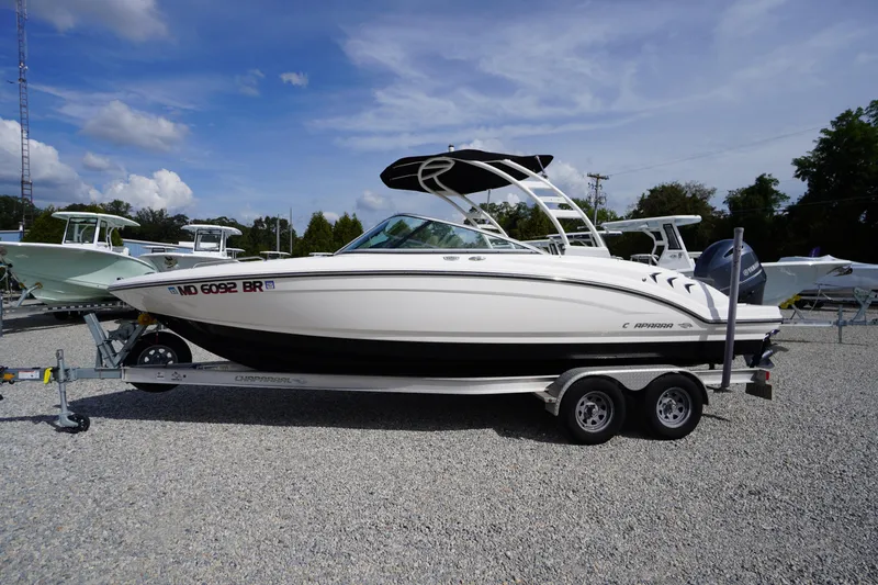 The Image of 2022 Chaparral 23 SSi OB boat on trailer, parked outdoors under blue sky. - 0