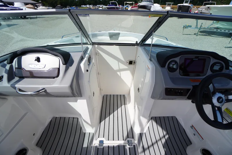 Slide: The Image of 2022 Chaparral 23 SSi OB boat interior with steering wheel and dashboard controls. - 11