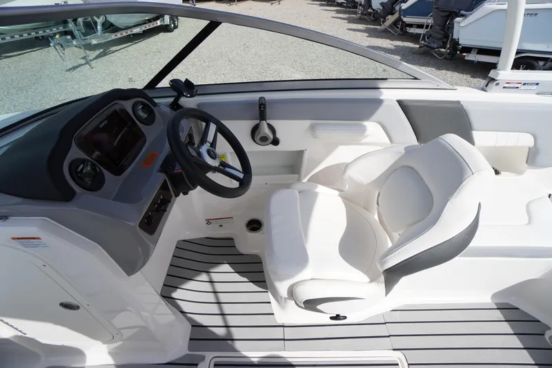 Slide: The Image of 2022 Chaparral 23 SSi OB boat interior with steering wheel and white seating. - 13