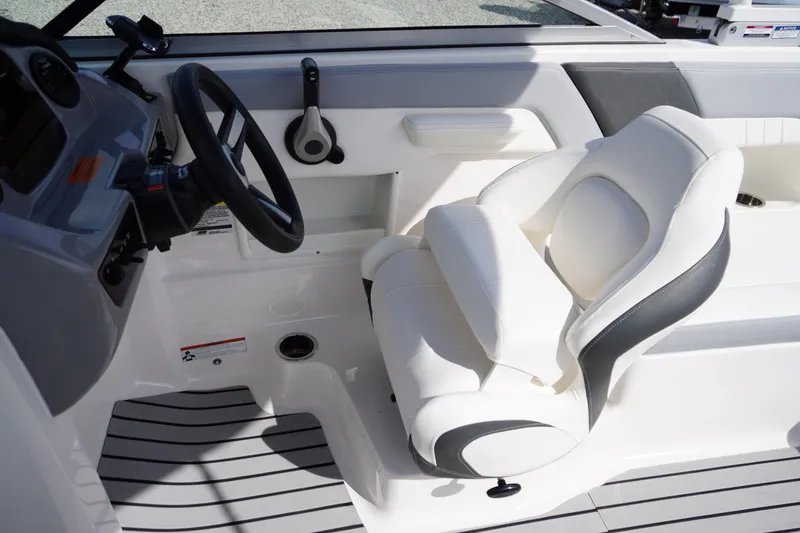 Slide: The Image of 2022 Chaparral 23 SSi OB boat interior with steering wheel and white seating. - 14