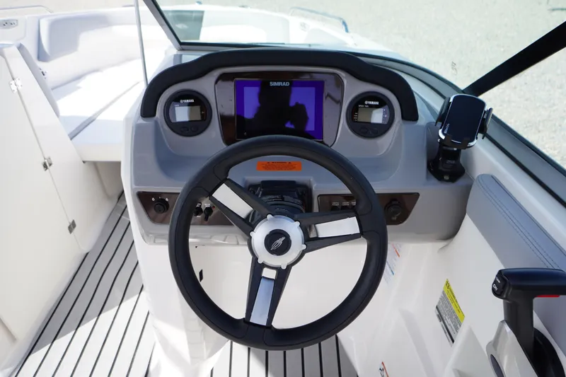 Slide: The Image of 2022 Chaparral 23 SSi OB boat dashboard with steering wheel and digital display. - 15