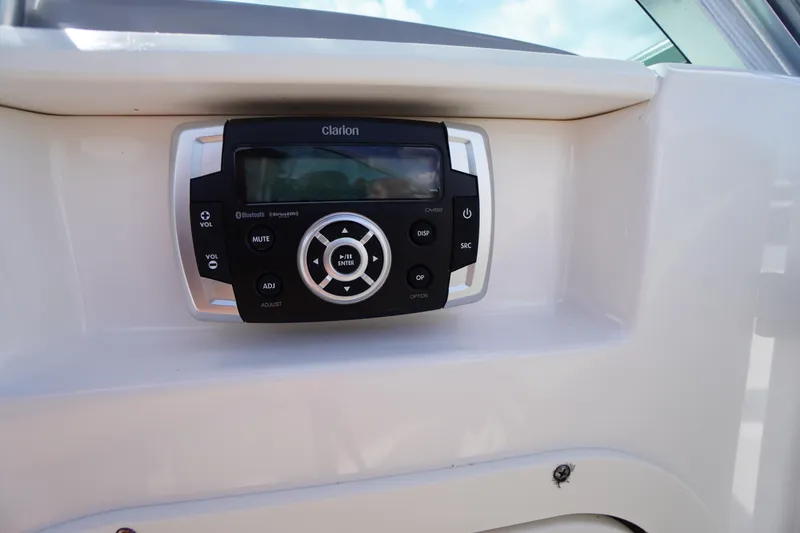 Slide: The Image of Clarion audio system on 2022 Chaparral 23 SSi OB boat dashboard. - 19